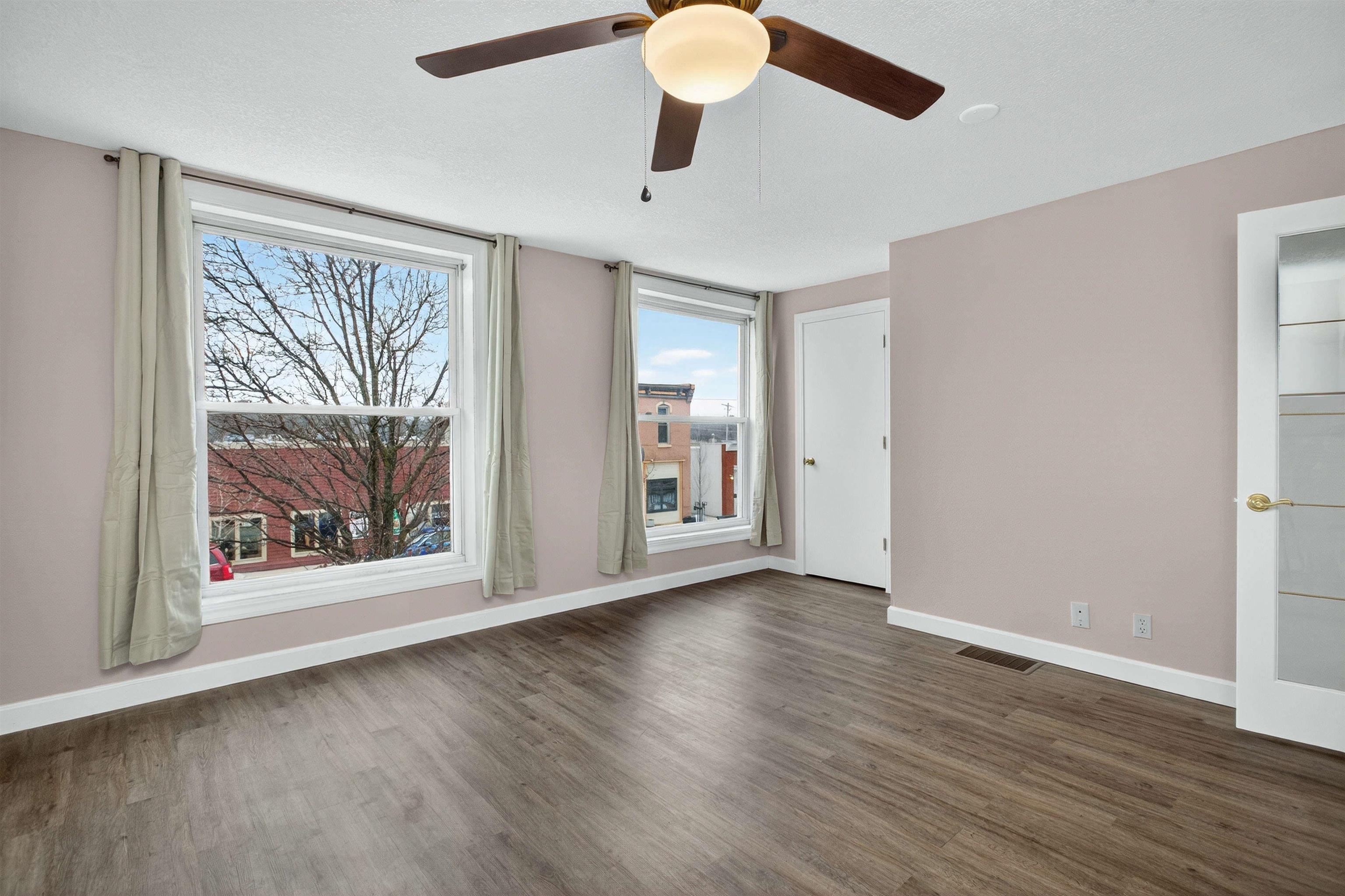 118 North Cody Road Leclaire, IA 52753 - Photo 34 of 42 a view of an empty room with wooden floor and a window