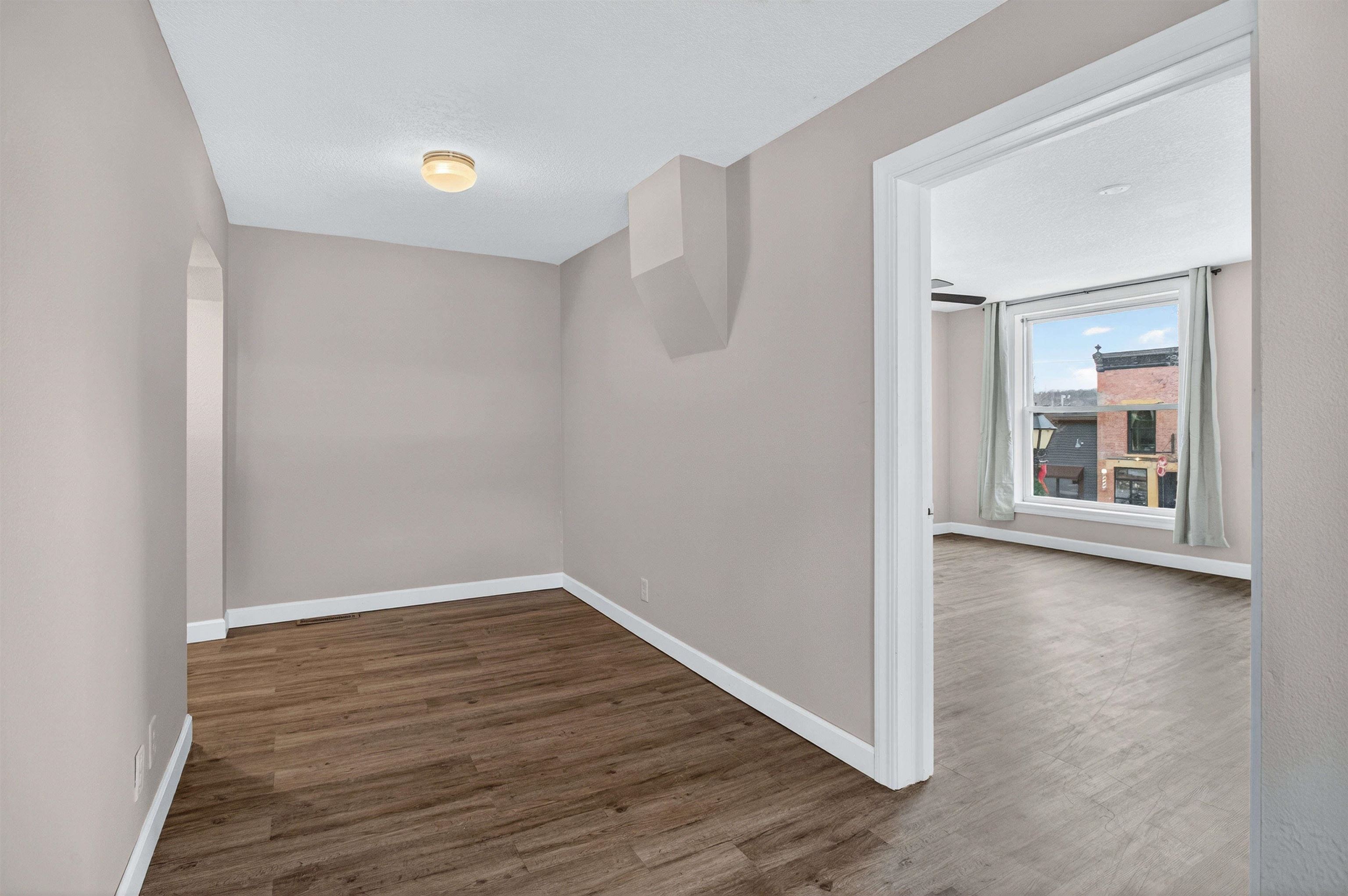 118 North Cody Road Leclaire, IA 52753 - Photo 36 of 42 an empty room with wooden floor and windows