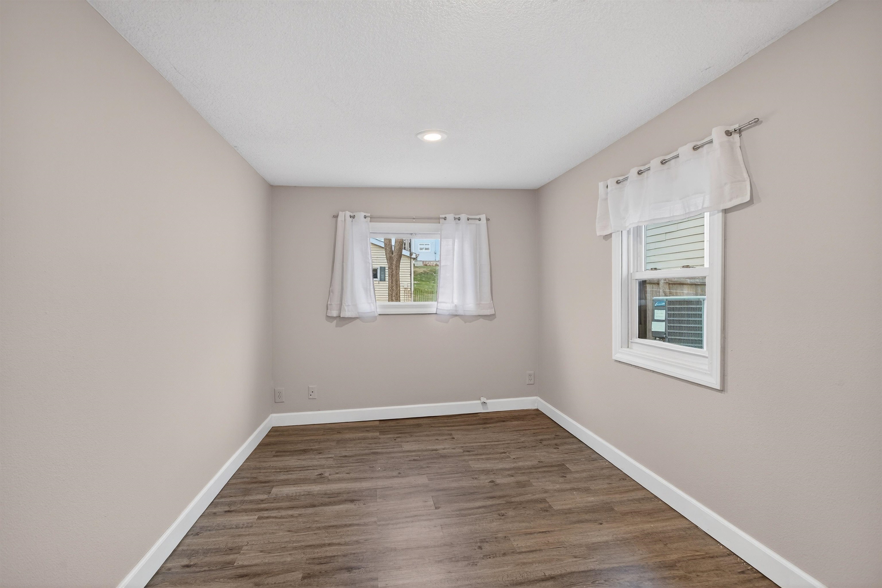 118 North Cody Road Leclaire, IA 52753 - Photo 40 of 42 wooden floor in an empty room with a window