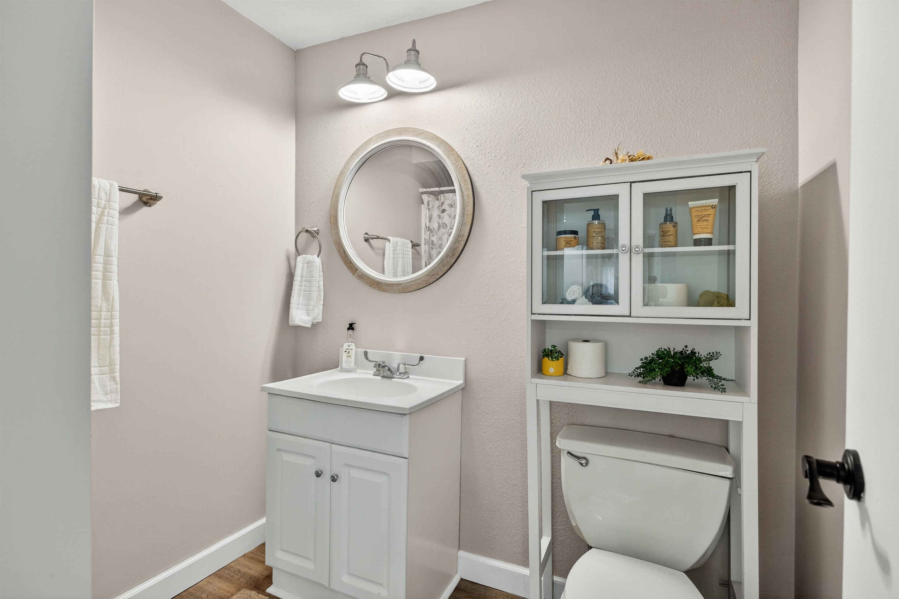 118 North Cody Road Leclaire, IA 52753 - Photo 42 of 42 a bathroom with a toilet a sink and a mirror
