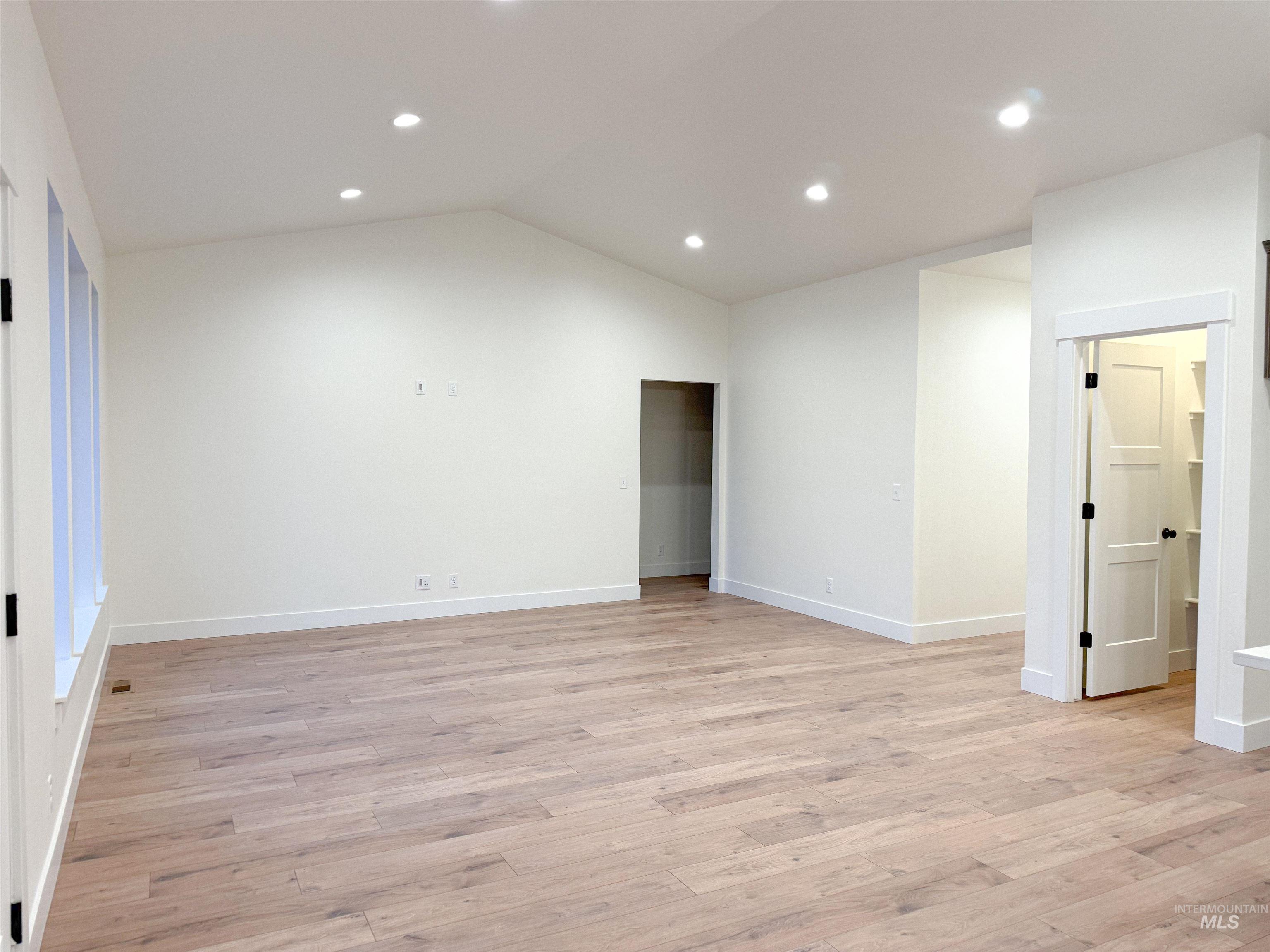 235 Whitman Street Albion, ID 83311 - Photo 11 of 23 Unfurnished room featuring lofted ceiling, light wood-style flooring, and recessed lighting
