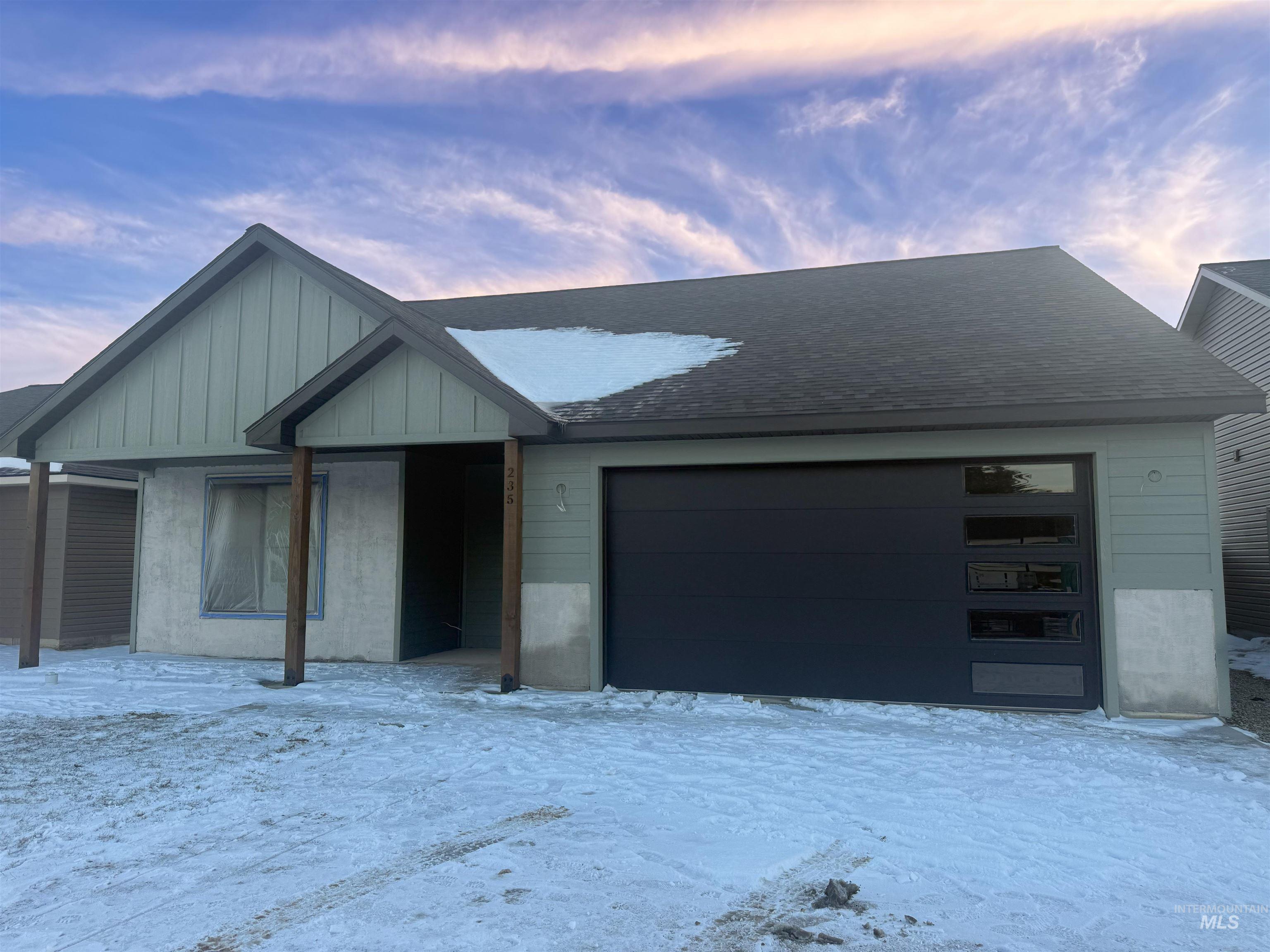 235 Whitman Street Albion, ID 83311 - Photo 2 of 8 View of front facade featuring roof with shingles and an attached garage