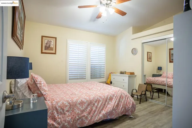 a bedroom with a bed and a flat tv screen on dresser