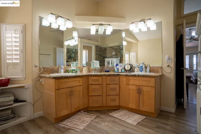a kitchen with stainless steel appliances granite countertop a sink a stove and cabinets