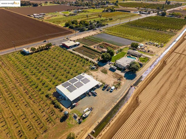 a view of a patio with couches table and chairs and potted plants