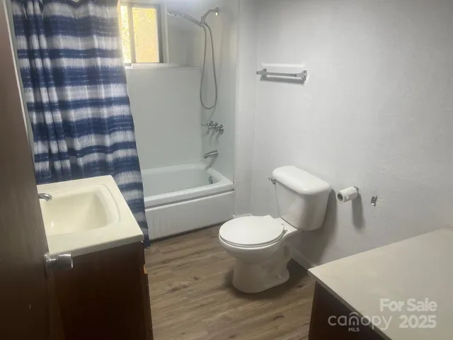 a white toilet sitting next to a bathroom sink