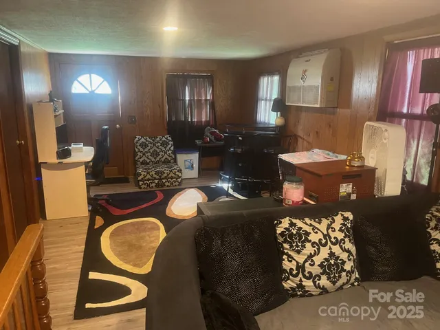 a living room with furniture and a lamp