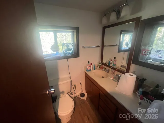 a bathroom with a sink mirror and toilet