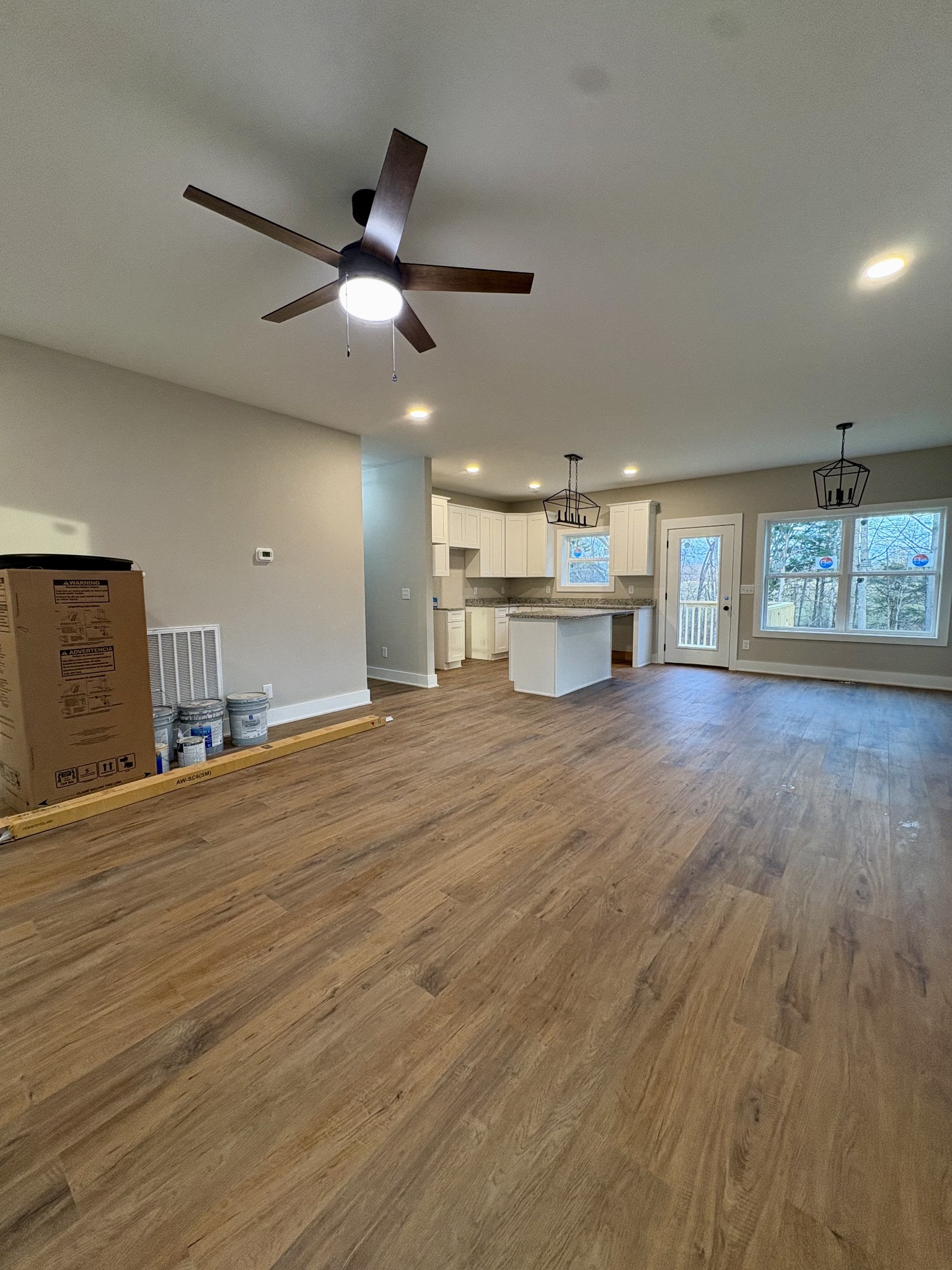 44 Ghea Road Normandy, TN 37360 - Photo 3 of 10 an empty room with wooden floor fan and windows