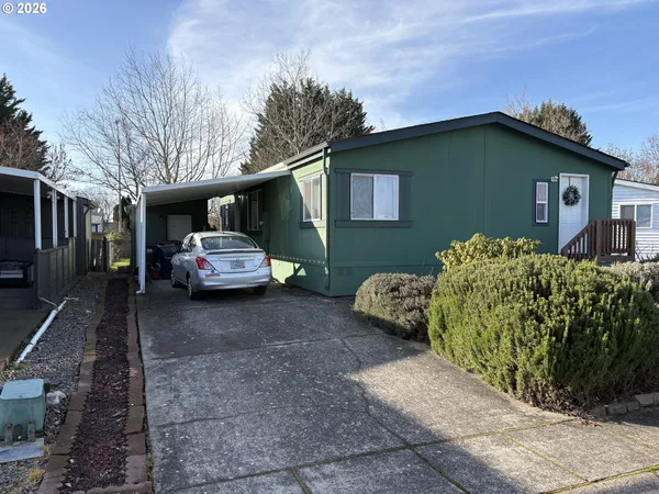 a couple of cars parked in front of a house