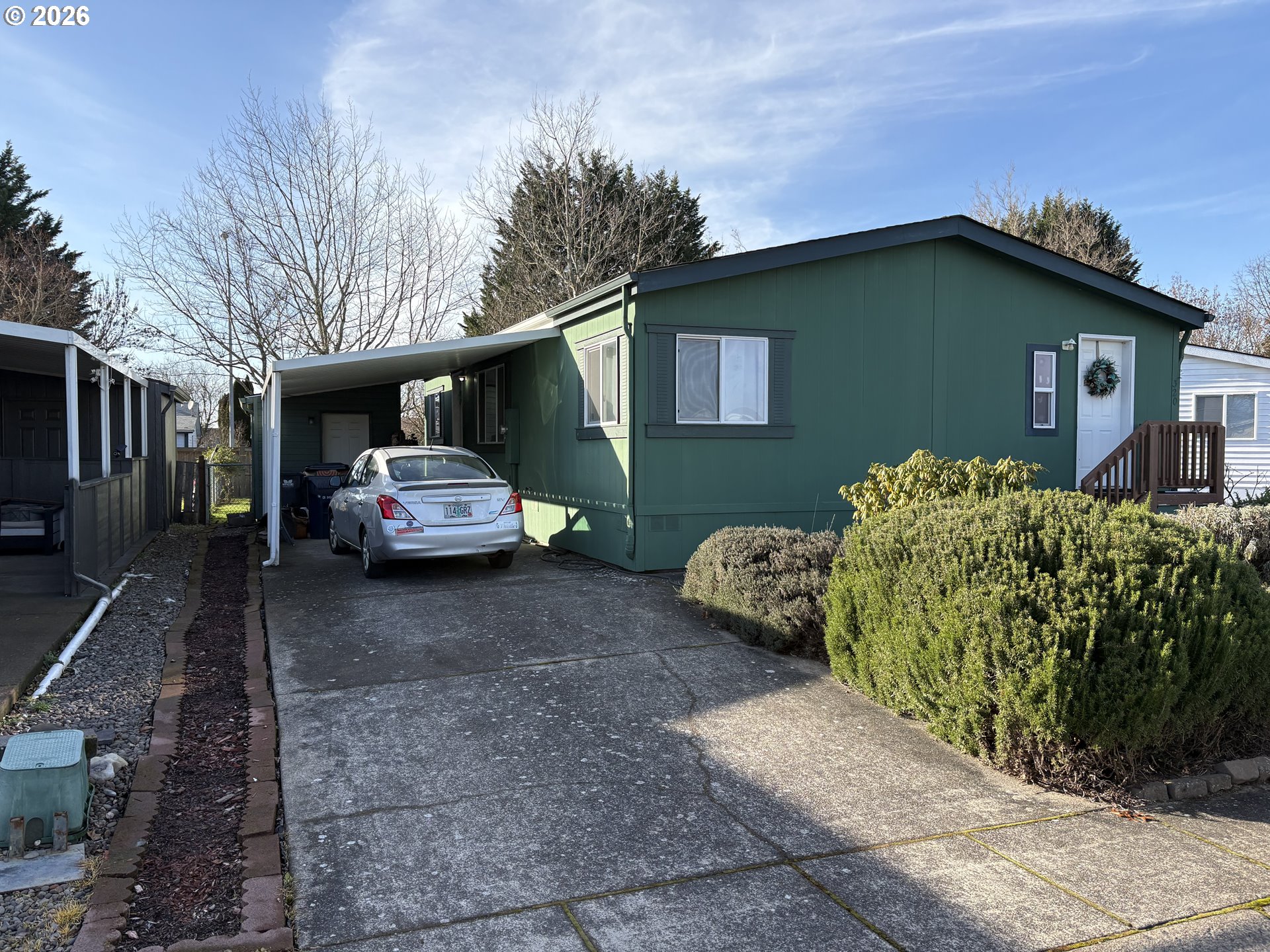 a couple of cars parked in front of a house