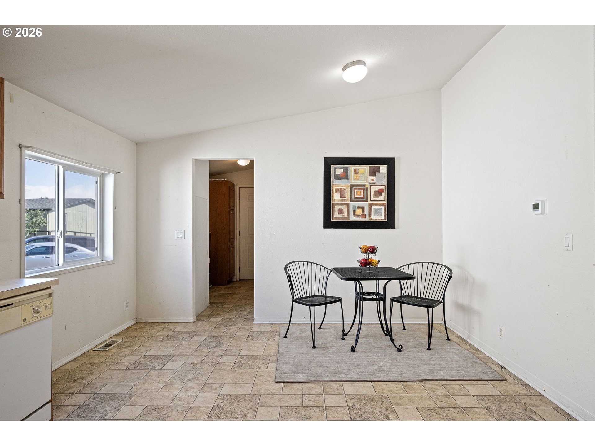 1699 North Terry Street, Unit 320 Eugene, OR 97402 - Photo 11 of 36 a view of a dining room with furniture and a window