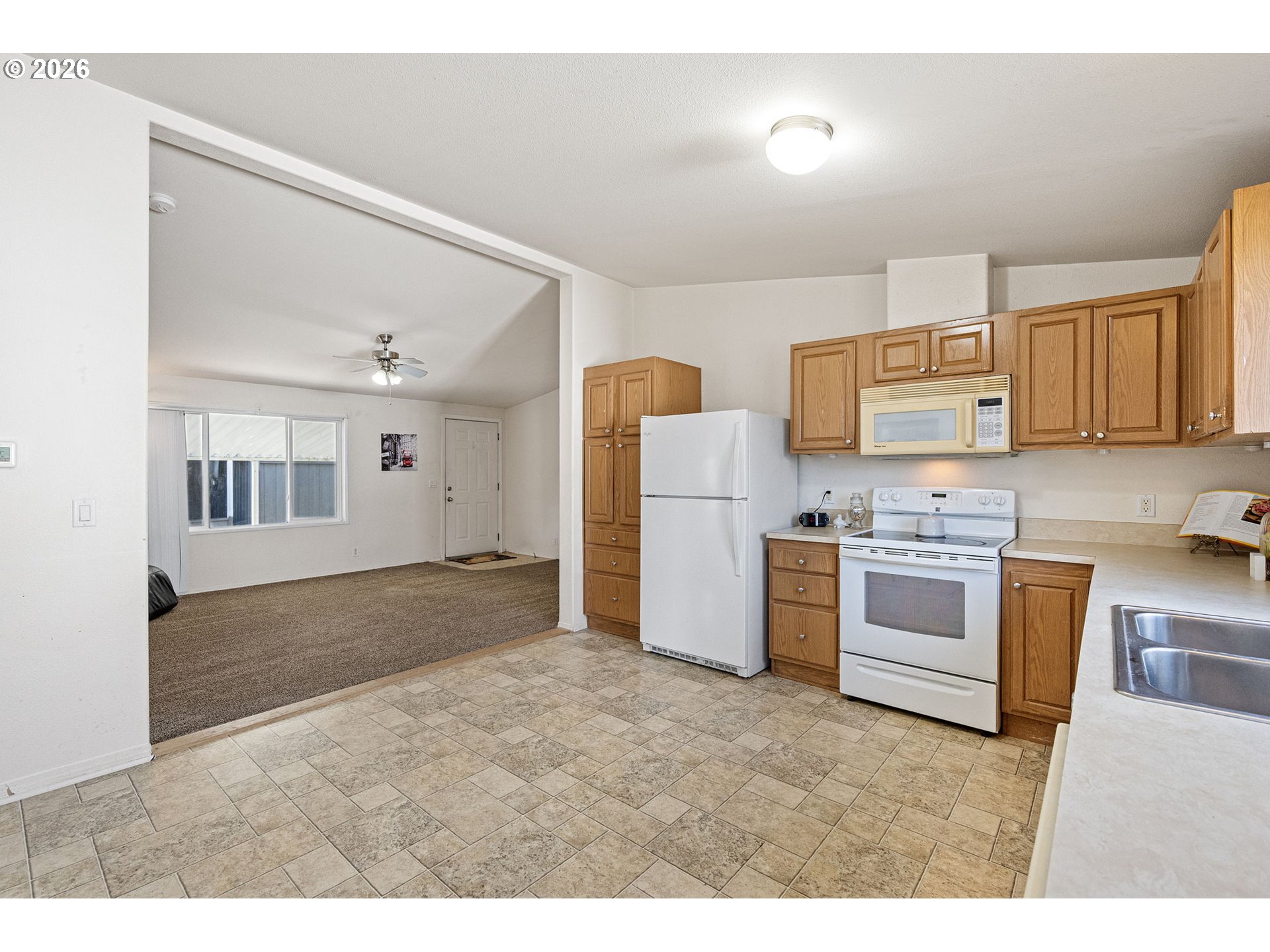 1699 North Terry Street, Unit 320 Eugene, OR 97402 - Photo 17 of 36 a kitchen with a refrigerator stove and sink