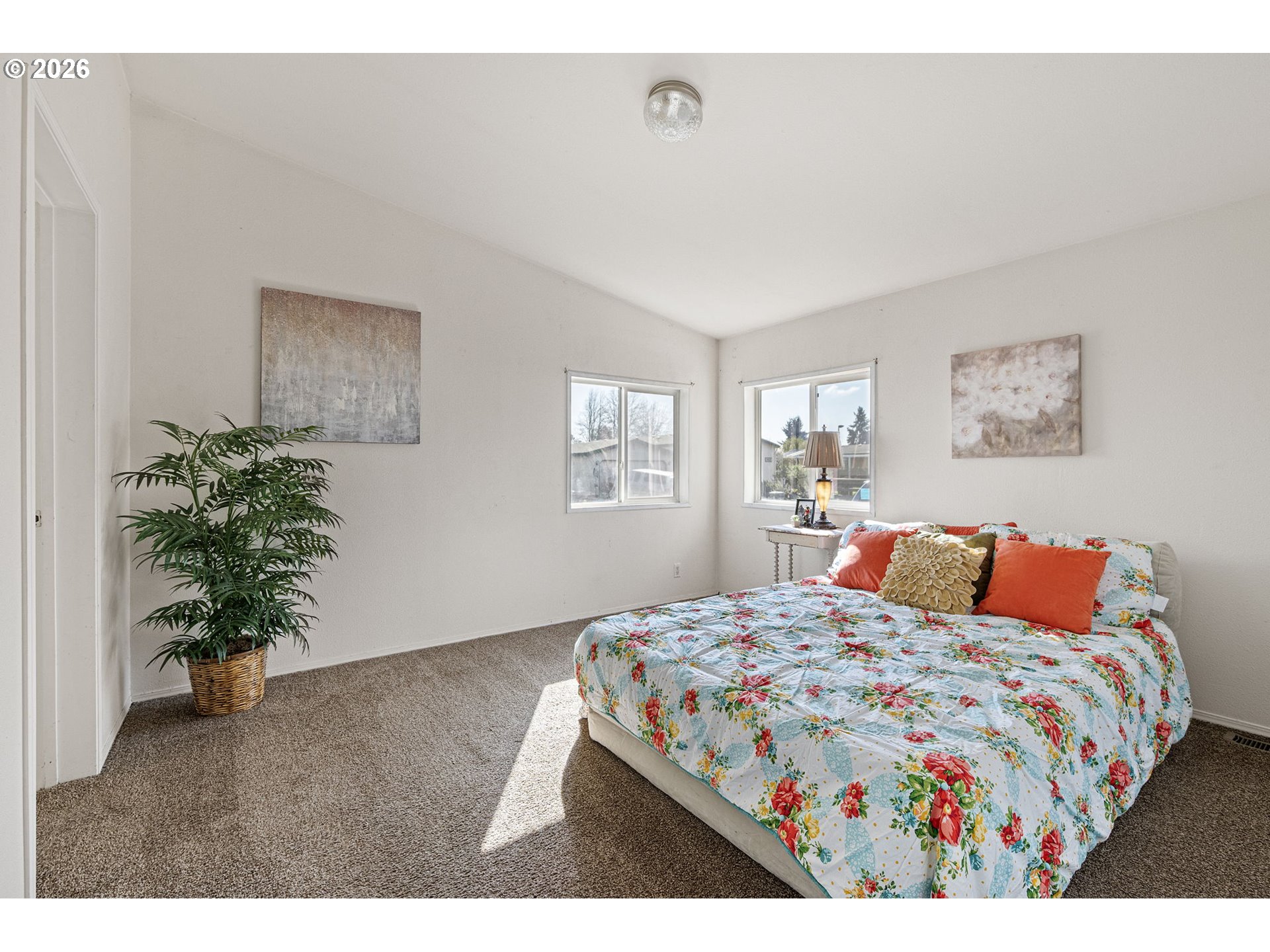 1699 North Terry Street, Unit 320 Eugene, OR 97402 - Photo 19 of 36 a bedroom with a bed and a potted plant