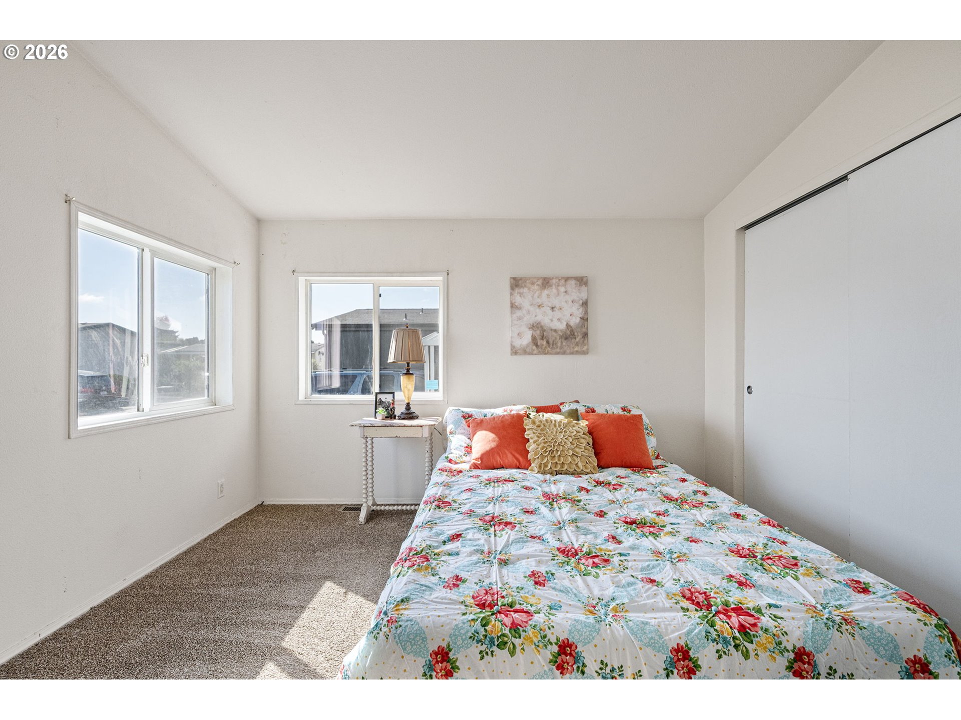 1699 North Terry Street, Unit 320 Eugene, OR 97402 - Photo 21 of 36 a bedroom with a bed and wooden floor