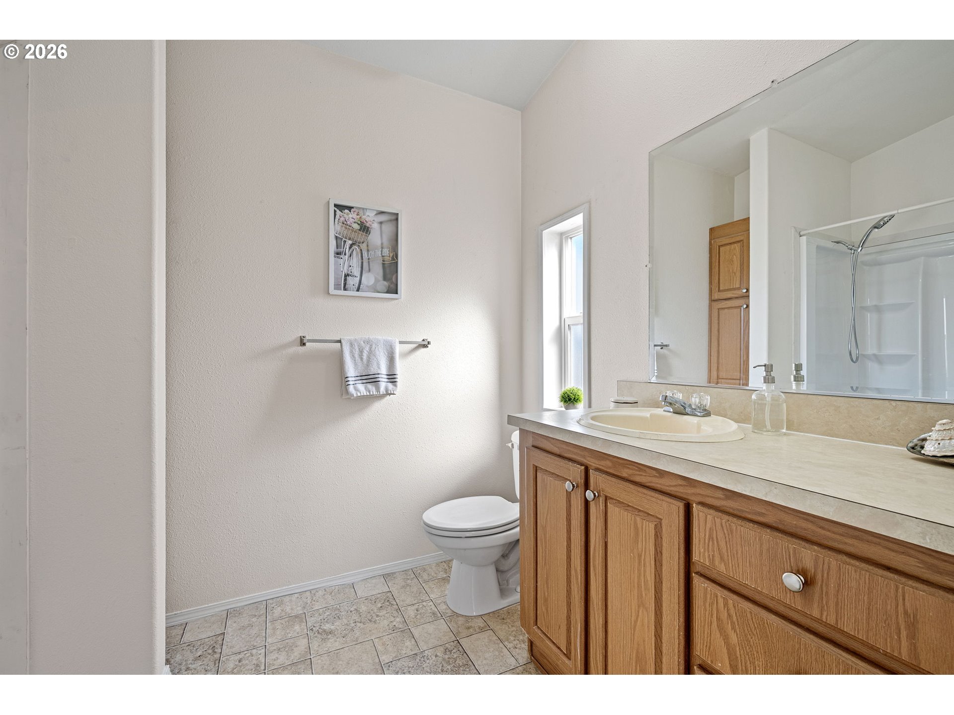 1699 North Terry Street, Unit 320 Eugene, OR 97402 - Photo 26 of 36 a bathroom with a granite countertop sink a toilet and a mirror