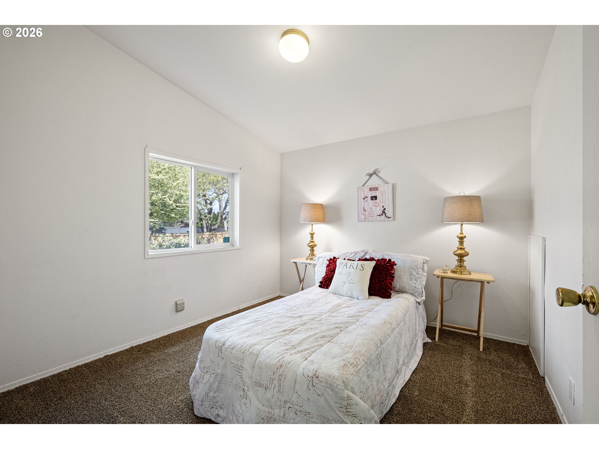1699 North Terry Street, Unit 320 Eugene, OR 97402 - Photo 28 of 36 a bedroom with a bed and a lamp