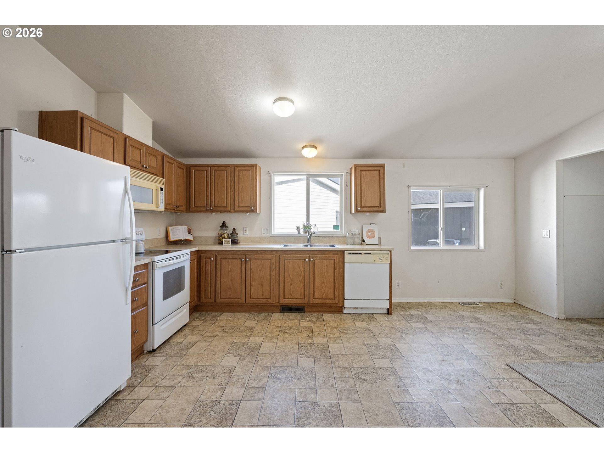 1699 North Terry Street, Unit 320 Eugene, OR 97402 - Photo 9 of 36 a kitchen with a refrigerator sink and cabinets