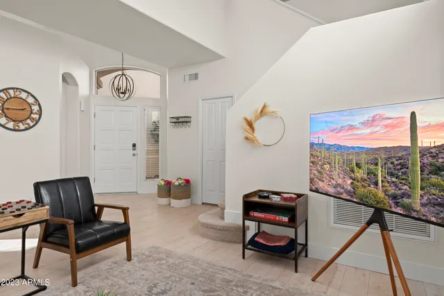a view of a dining room with furniture and chandelier