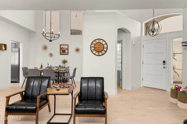 a living room with furniture a fireplace and a potted plant