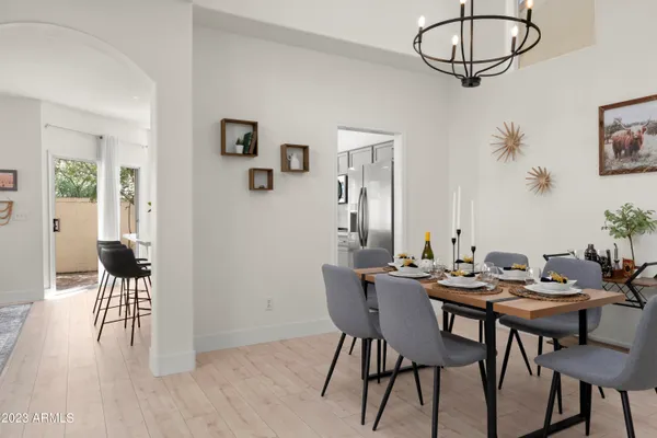 a kitchen with a table chairs refrigerator and cabinets