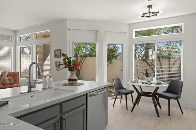 a bathroom with a granite countertop sink a toilet and shower