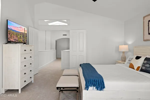 a bedroom with a bed and a large window