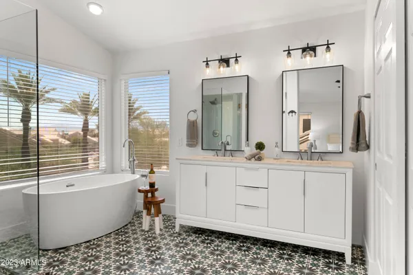 a view of a room that has a bed and a table in it