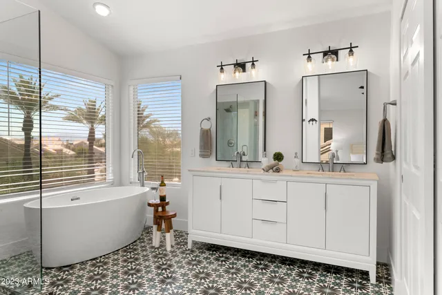 a view of a room that has a bed and a table in it