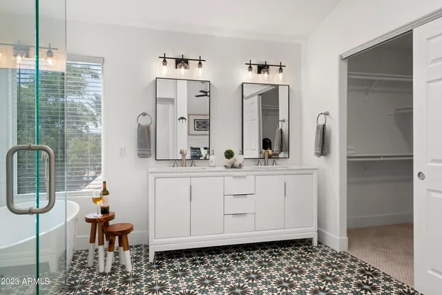 a view of a patio with table and chairs and floor to ceiling window