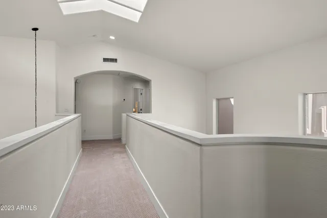 a patio with a table and chairs and potted plants