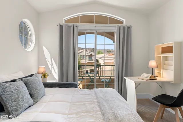 a view of a chairs and table in patio with a lake view