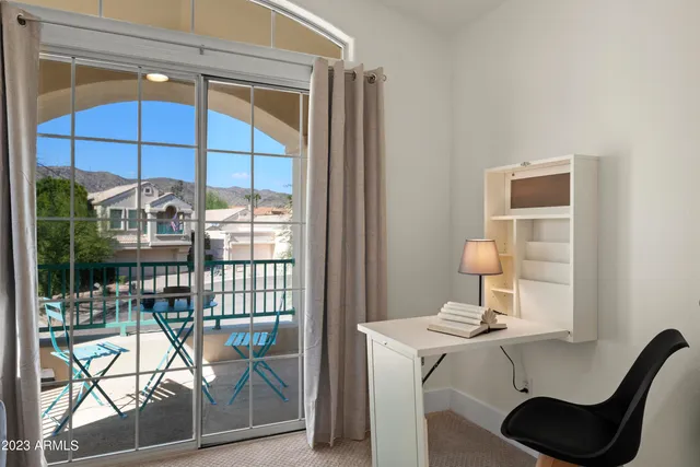 a view of a patio with a table chairs and a backyard