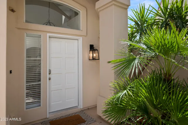 a living room with furniture a flat screen tv and a table