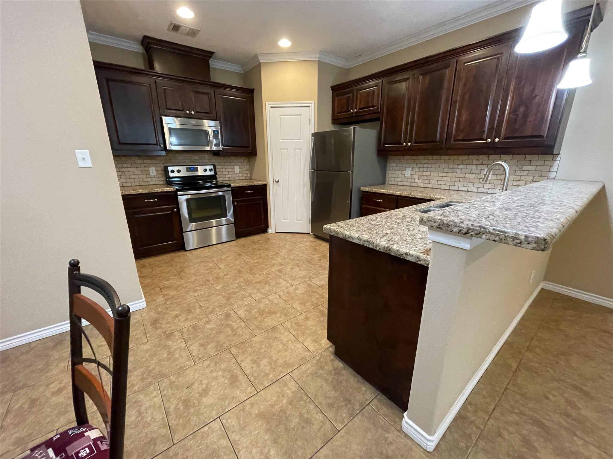 3519 Haverford Road College Station, TX 77845 - Photo 3 of 15 a kitchen with stainless steel appliances granite countertop a refrigerator stove and a sink