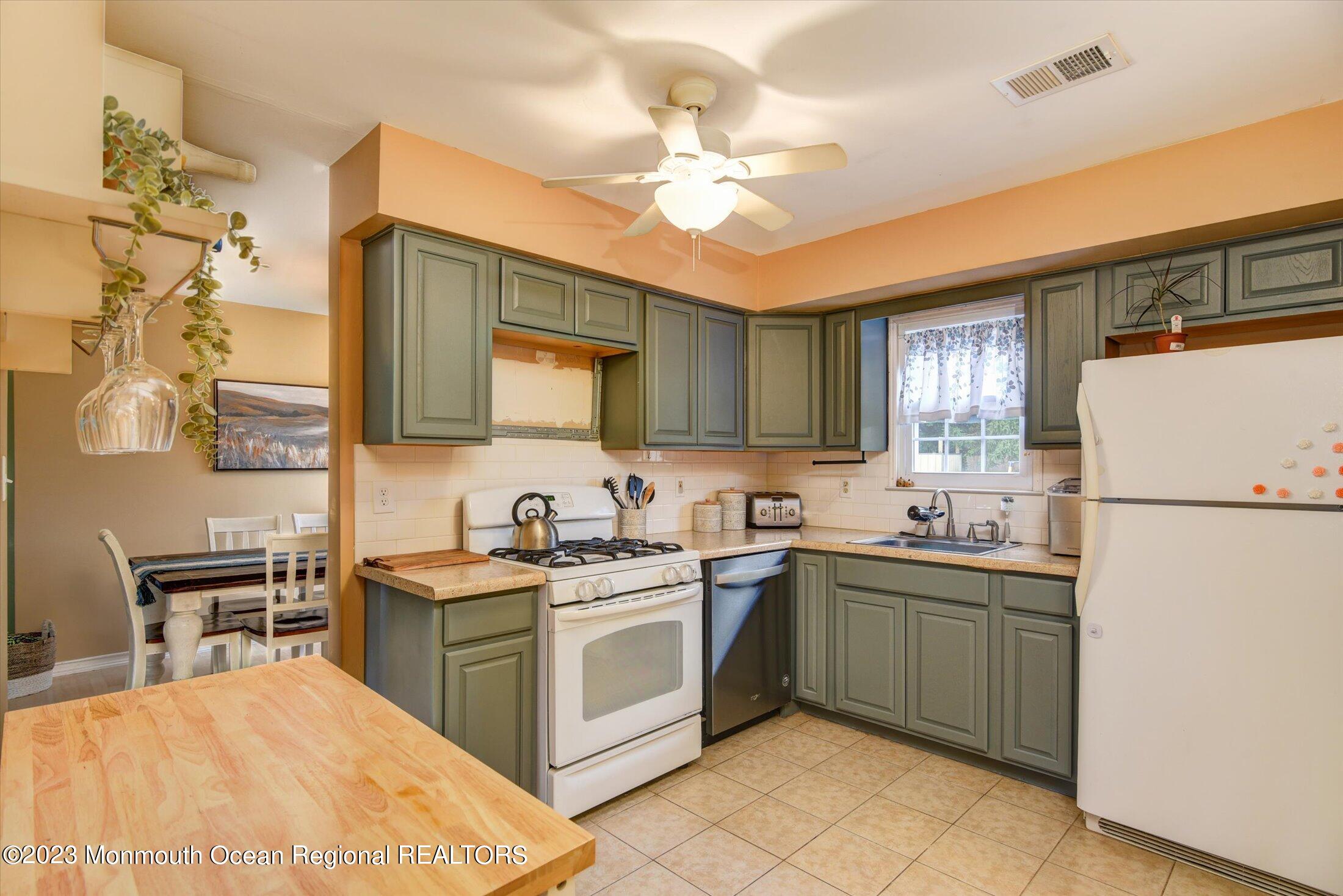 3 Albatross Drive Howell, NJ 07731 - Photo 11 of 29 a kitchen with a sink a stove a refrigerator and cabinets
