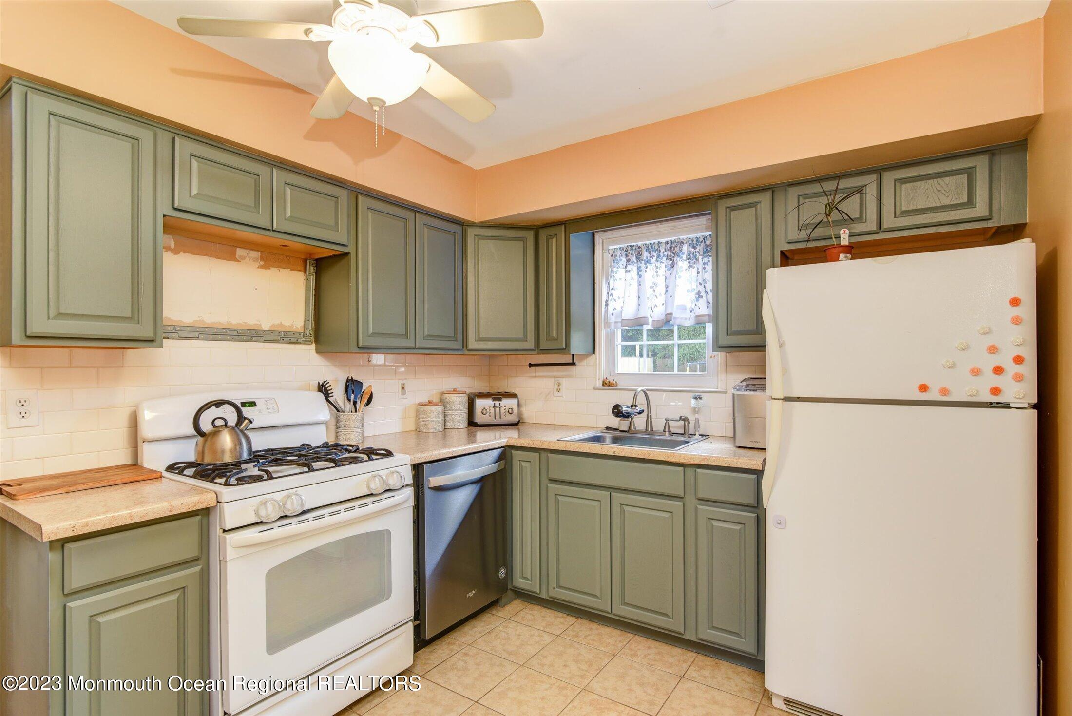 3 Albatross Drive Howell, NJ 07731 - Photo 12 of 29 a kitchen with a sink a refrigerator and cabinets