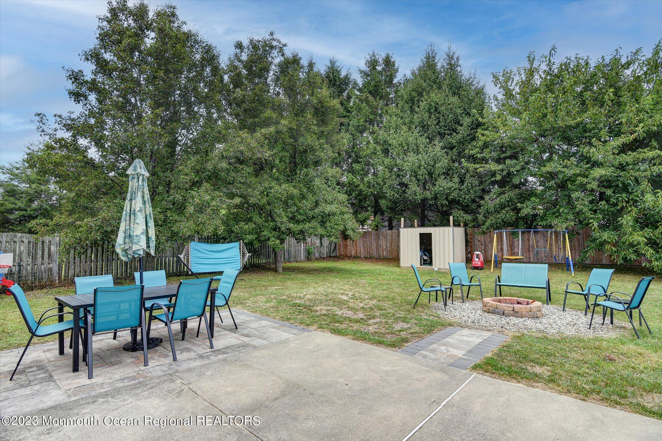 3 Albatross Drive Howell, NJ 07731 - Photo 28 of 29 a backyard of a house with table and chairs