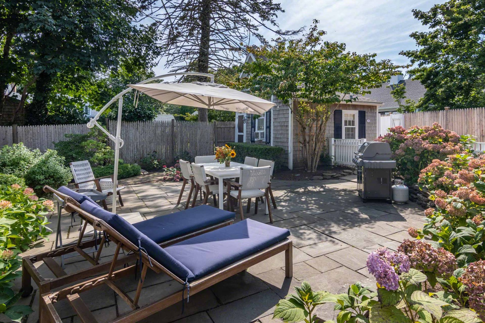 10 Peases Point Way North Edgartown, MA 02539 - Photo 3 of 45 a view of a patio with a table and chairs under an umbrella