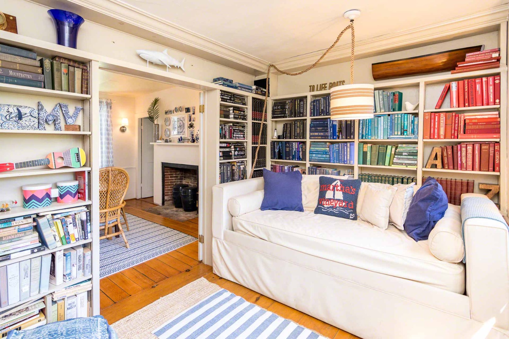 10 Peases Point Way North Edgartown, MA 02539 - Photo 21 of 45 a living room with fireplace furniture and a book shelf