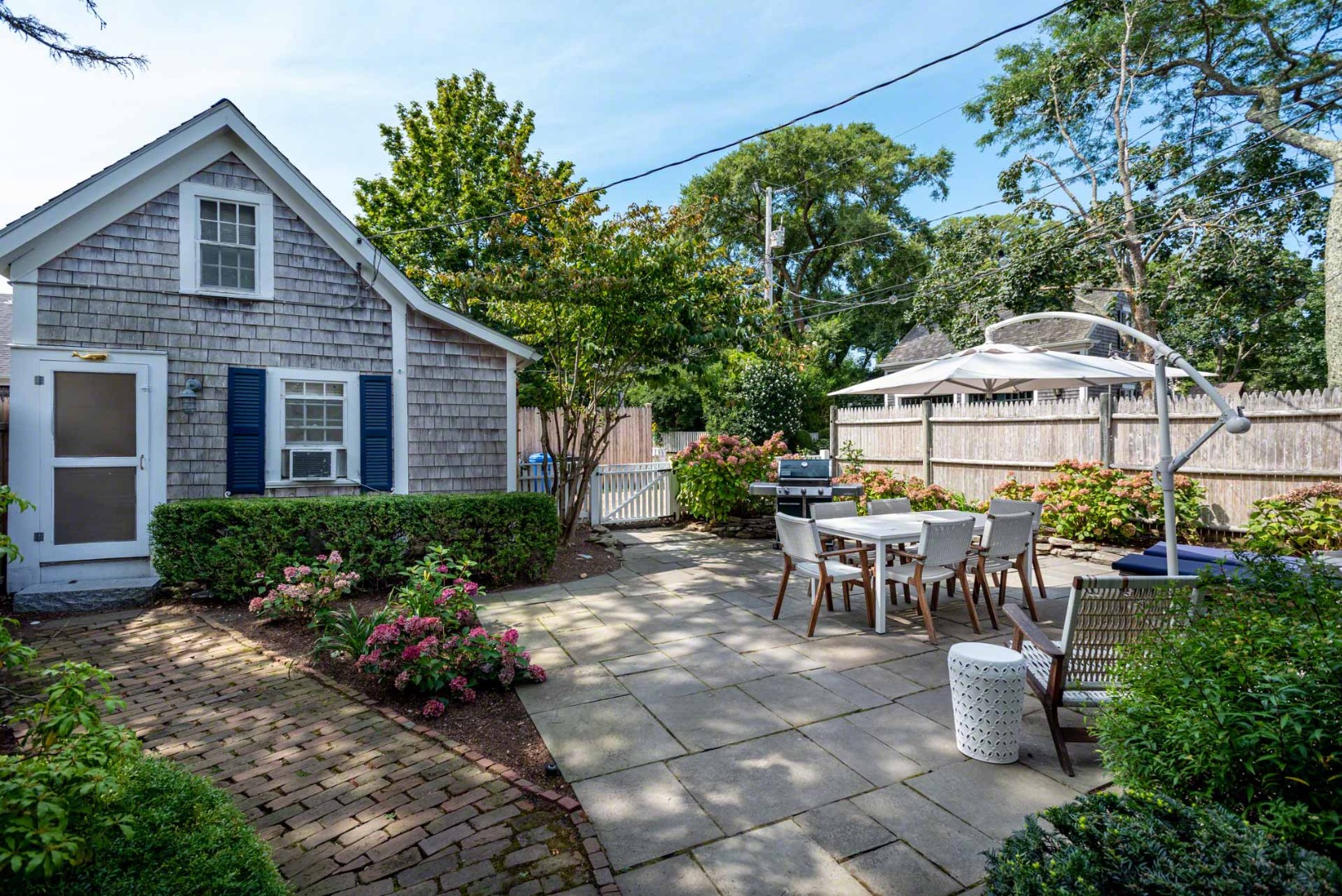 10 Peases Point Way North Edgartown, MA 02539 - Photo 42 of 45 a front view of a house with porch and garden