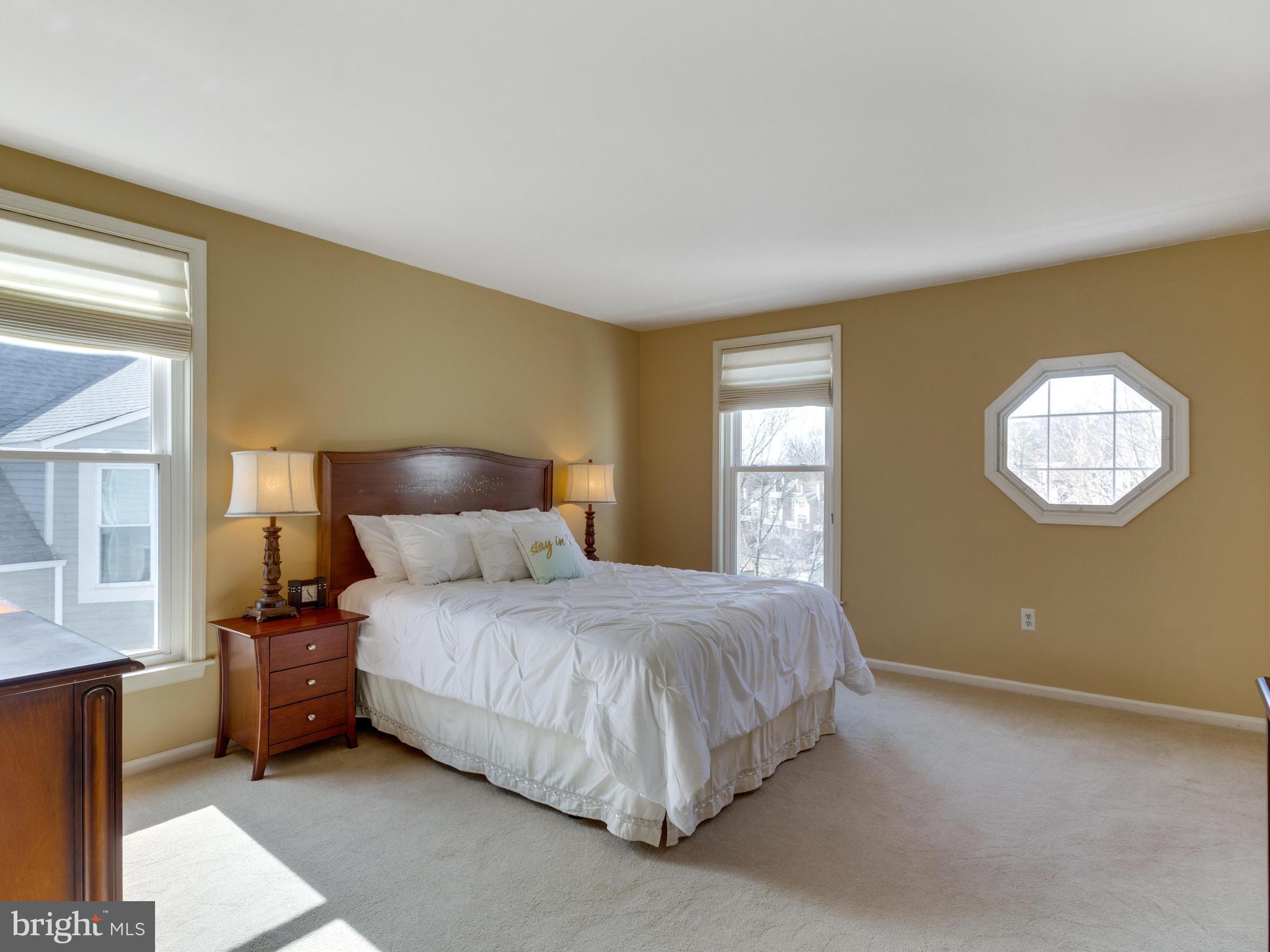 2072 Lake Audubon Court Reston, VA 20191 - Photo 13 of 30 a bedroom with a bed lamp and a window
