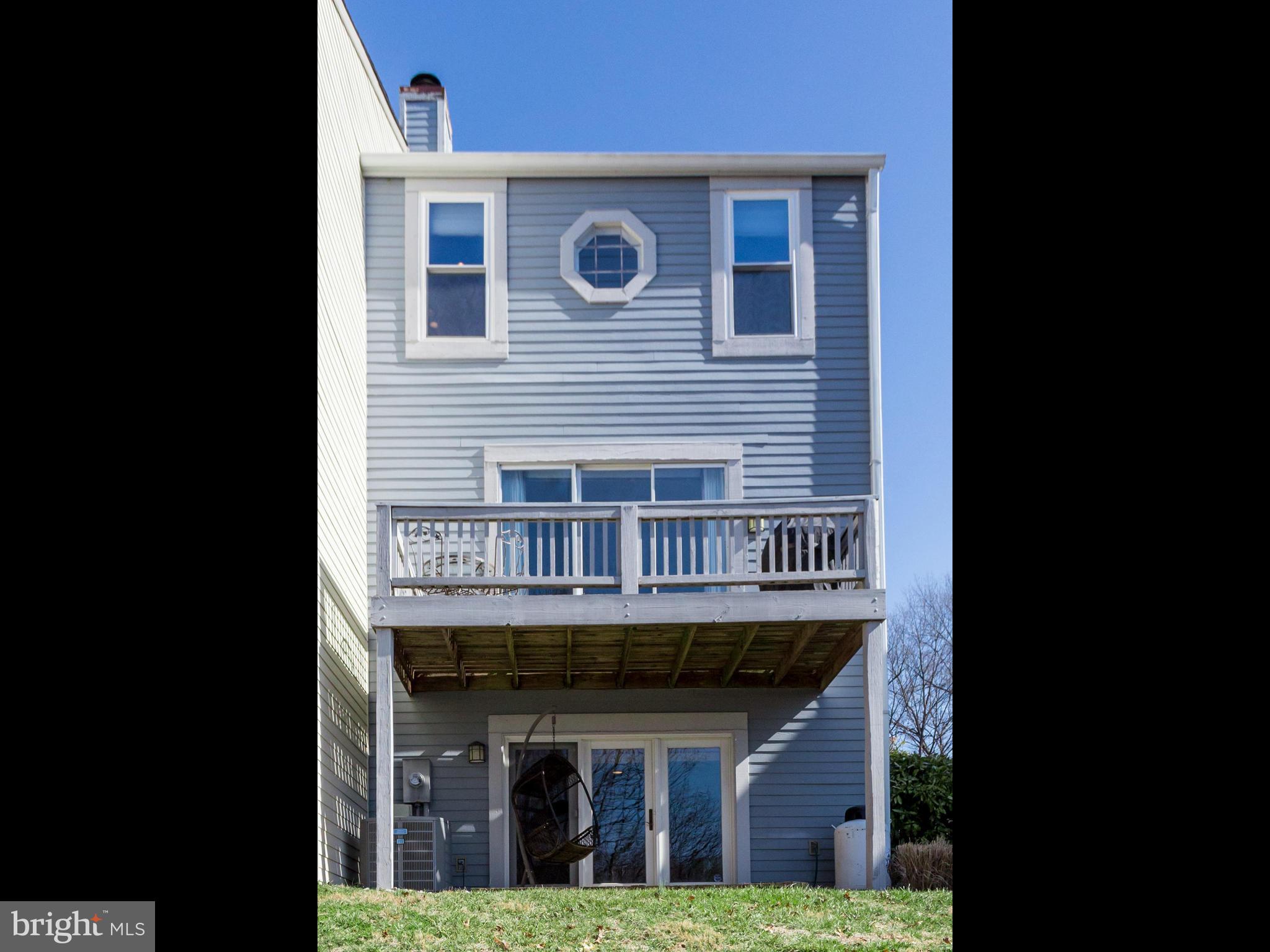 2072 Lake Audubon Court Reston, VA 20191 - Photo 27 of 30 a view of a brick house with large windows and a small yard