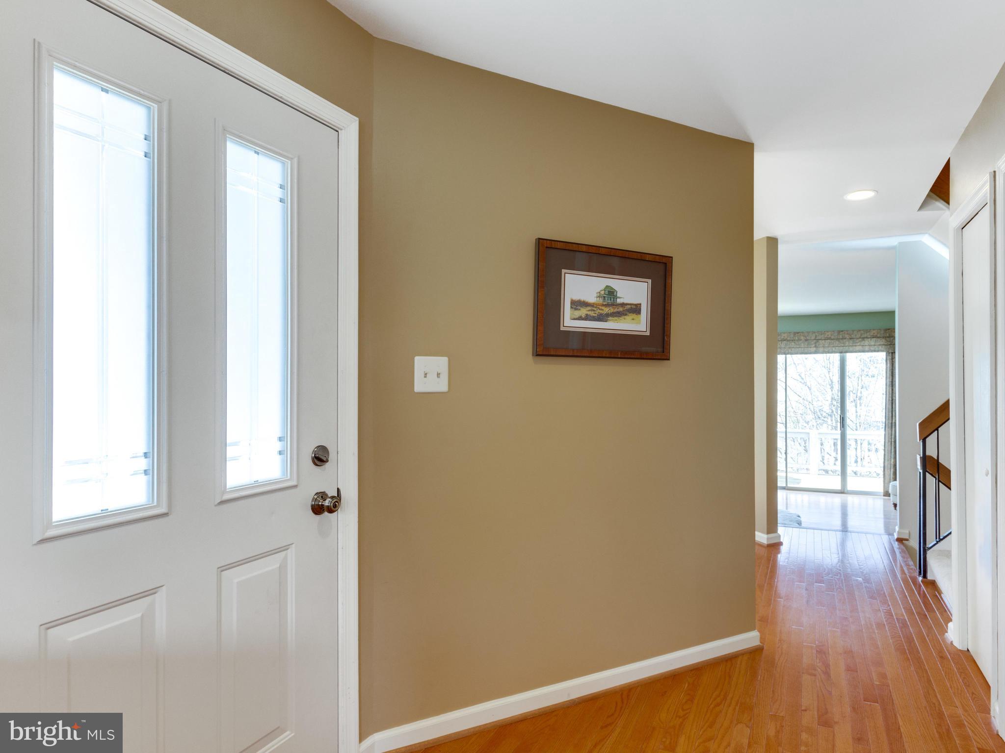 2072 Lake Audubon Court Reston, VA 20191 - Photo 4 of 30 a view of a hallway with wooden floor and a living room