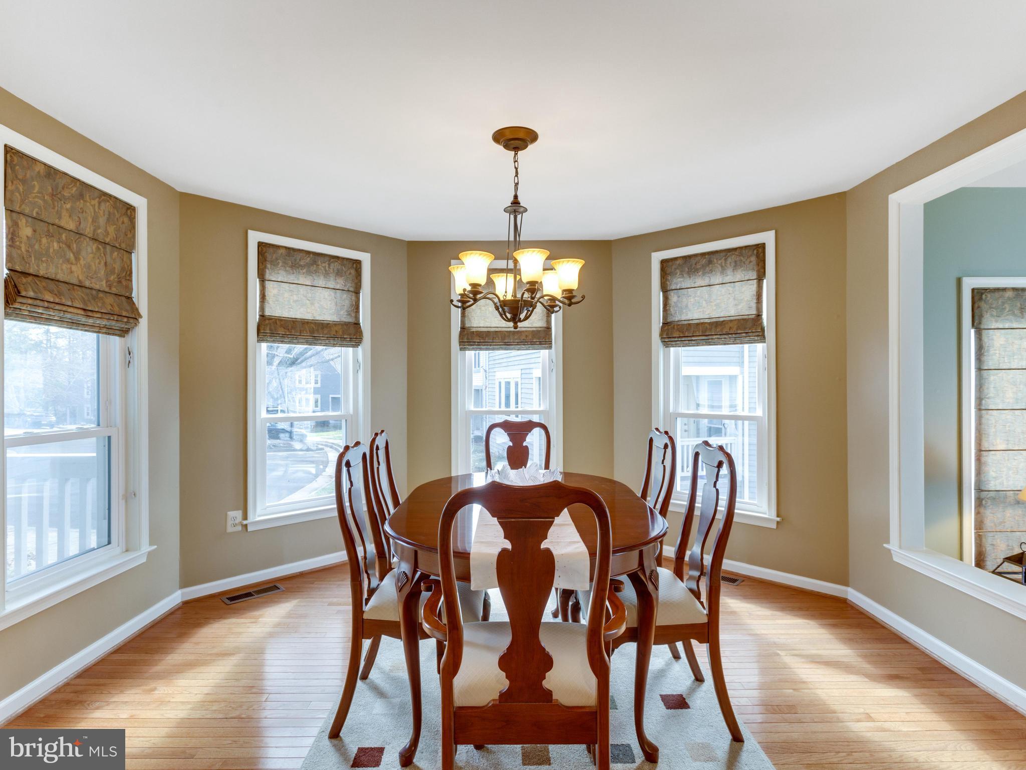2072 Lake Audubon Court Reston, VA 20191 - Photo 7 of 30 a dining room with furniture a chandelier and wooden floor