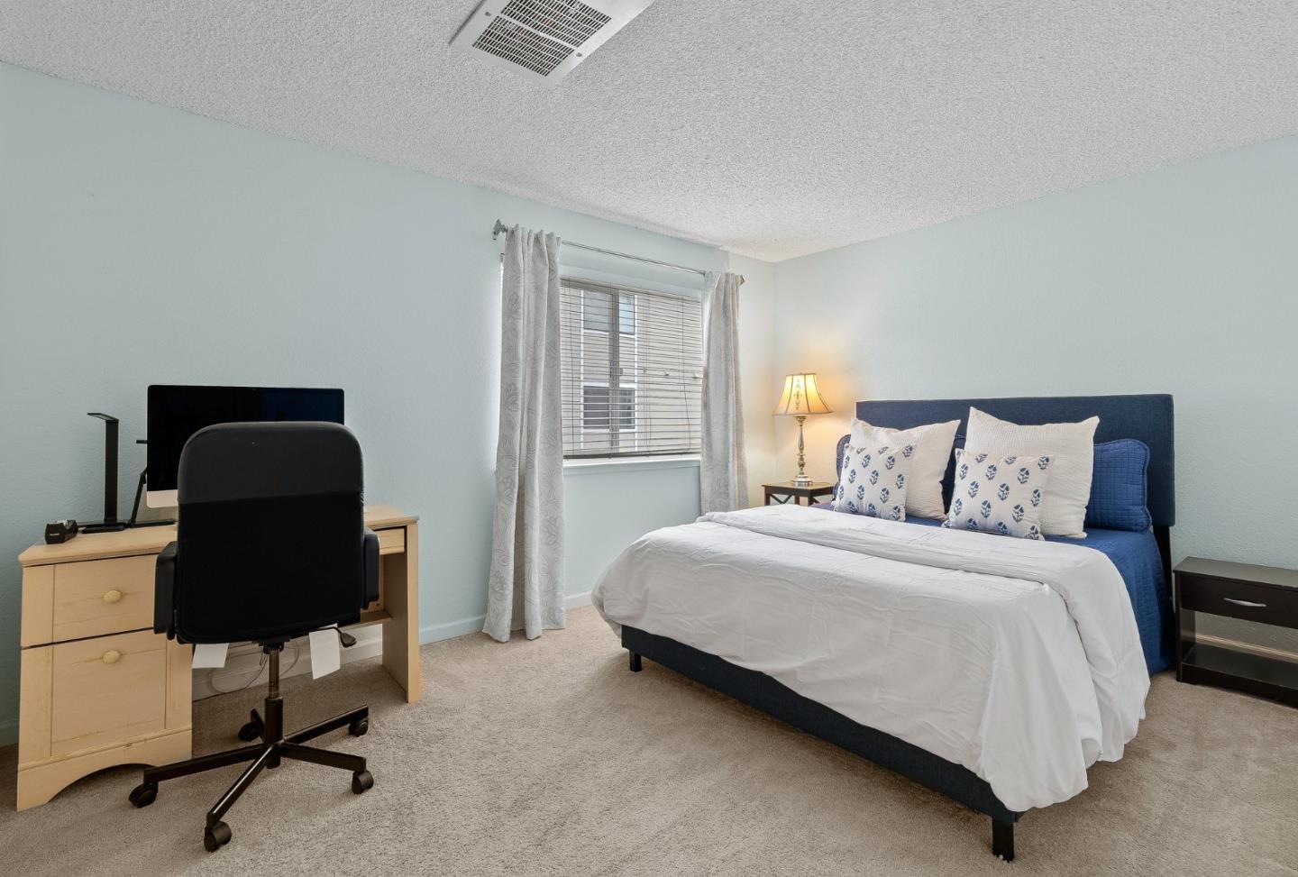 230 Stonegate Circle San Jose, CA 95110 - Photo 11 of 18 a bedroom with a bed a desk and chair