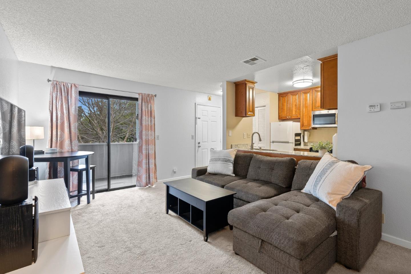 230 Stonegate Circle San Jose, CA 95110 - Photo 4 of 18 a living room with furniture and a large window