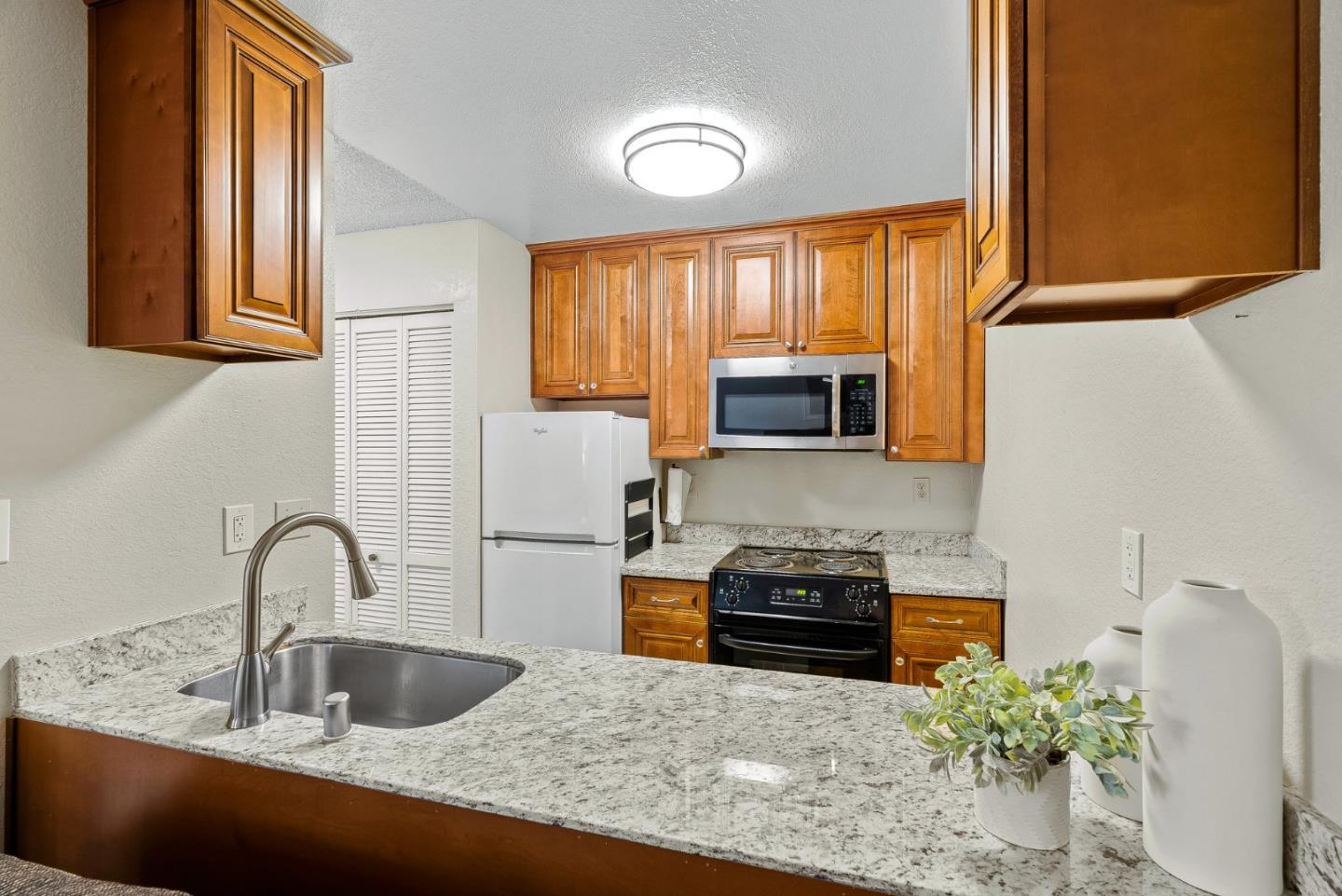 230 Stonegate Circle San Jose, CA 95110 - Photo 7 of 18 a kitchen with stainless steel appliances granite countertop a sink a stove and a microwave
