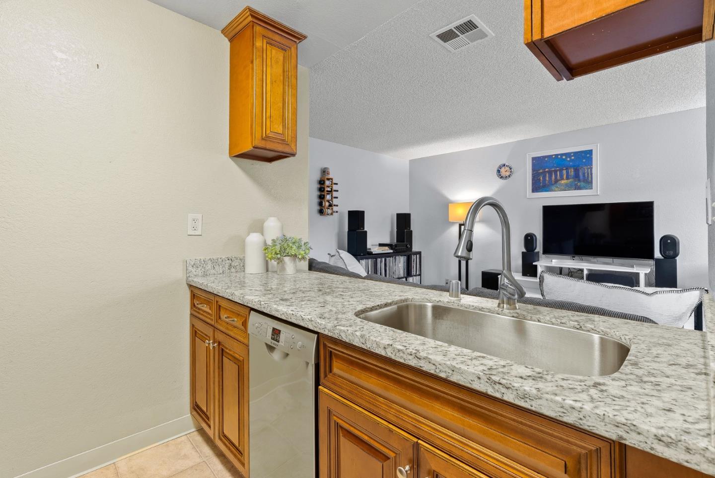 230 Stonegate Circle San Jose, CA 95110 - Photo 8 of 18 a kitchen with sink a faucet a potted plant and a window