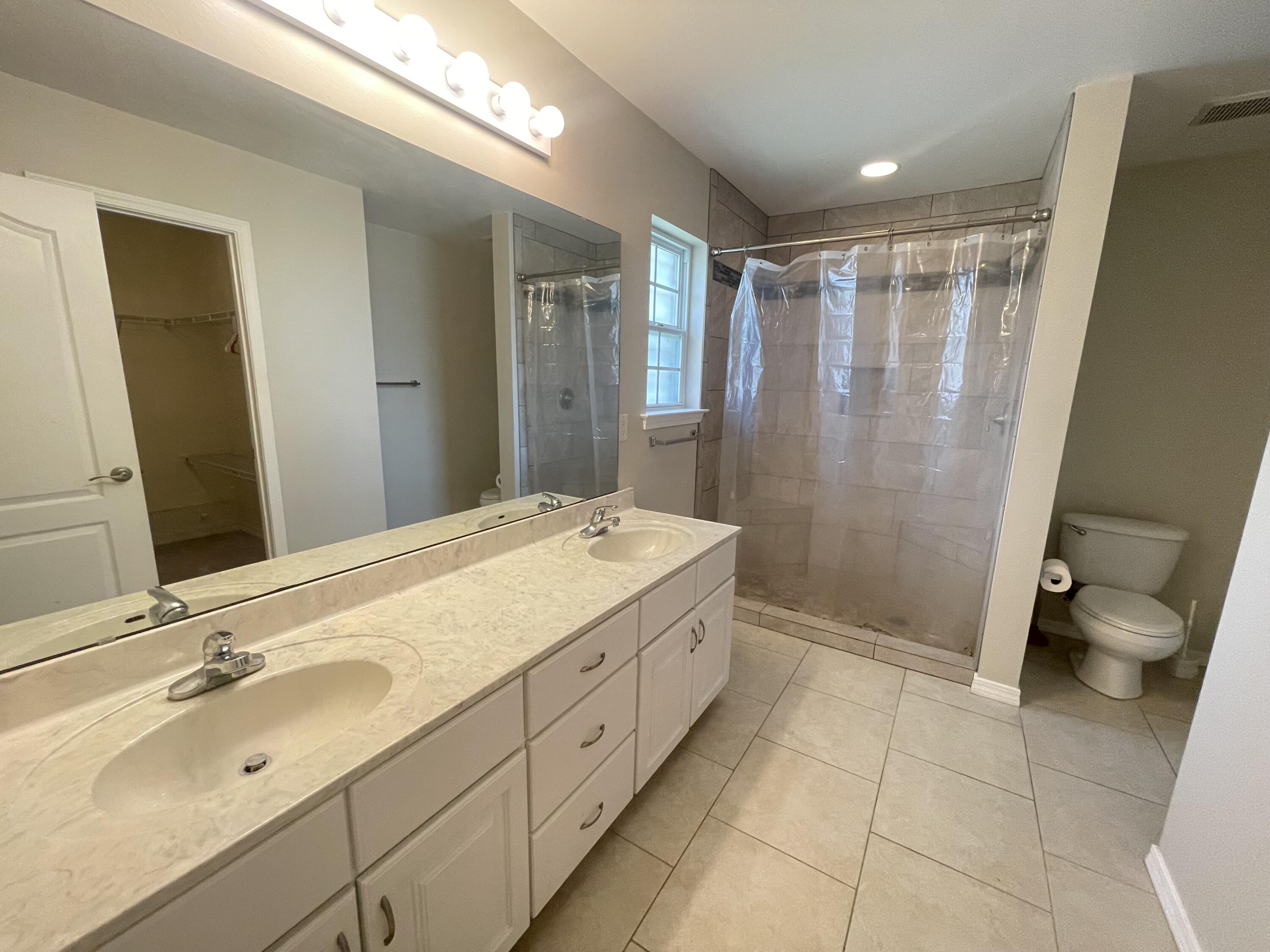 728 Riva Ridge Drive Crestview, FL 32539 - Photo 17 of 26 a bathroom with a double vanity sink toilet and shower